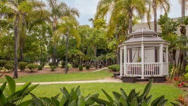 Green lawn and a white garden gazebo